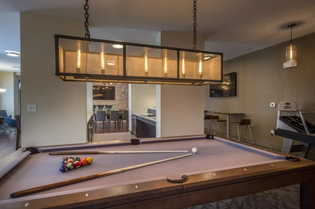 Clubhouse game room with Billiards table and lounge seating