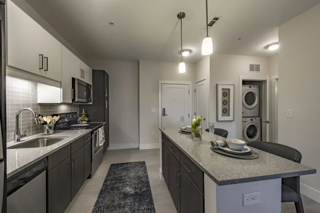 Kitchen with granite counters, stainless appliances, and tile backsplash